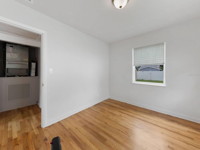 spare room featuring wood-type flooring