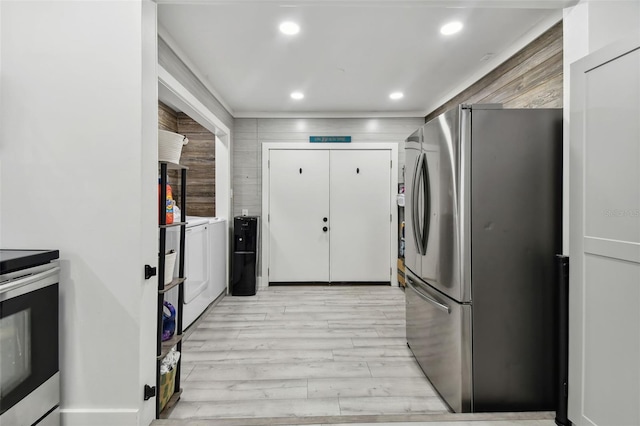 kitchen featuring white cabinets, stainless steel appliances, and light hardwood / wood-style flooring