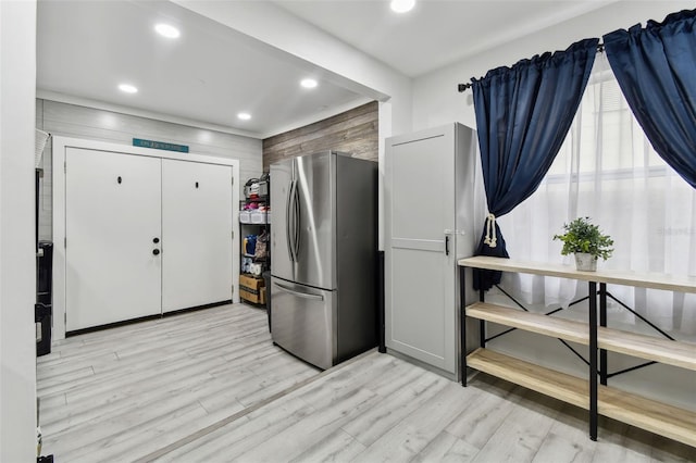 interior space featuring light wood-type flooring and stainless steel refrigerator