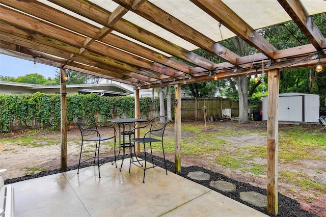 view of patio with a storage shed