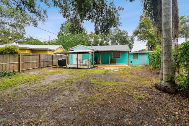 back of property featuring covered porch