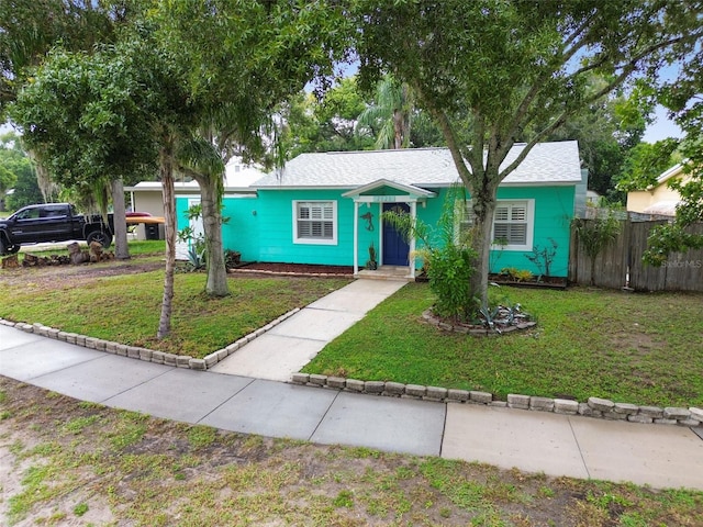 single story home featuring a front yard