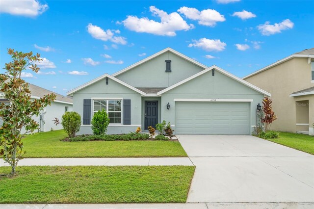 ranch-style house featuring a garage and a front lawn