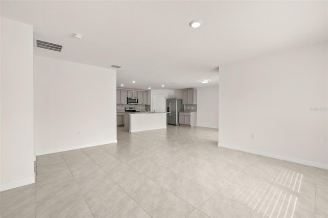 unfurnished living room with light tile patterned floors