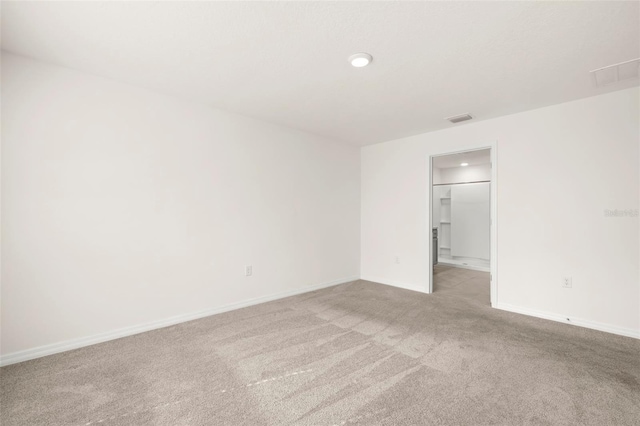 unfurnished room featuring light carpet