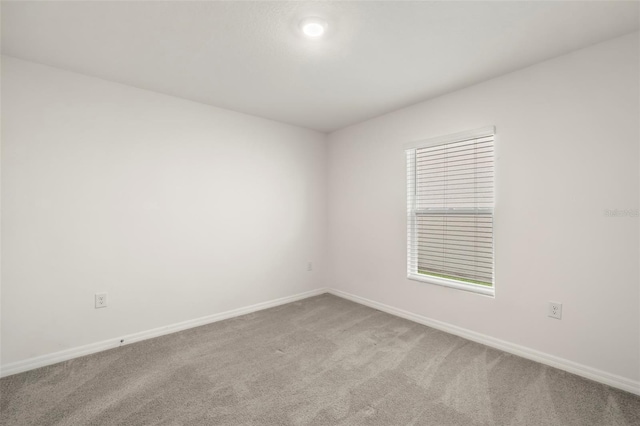 unfurnished room featuring light colored carpet