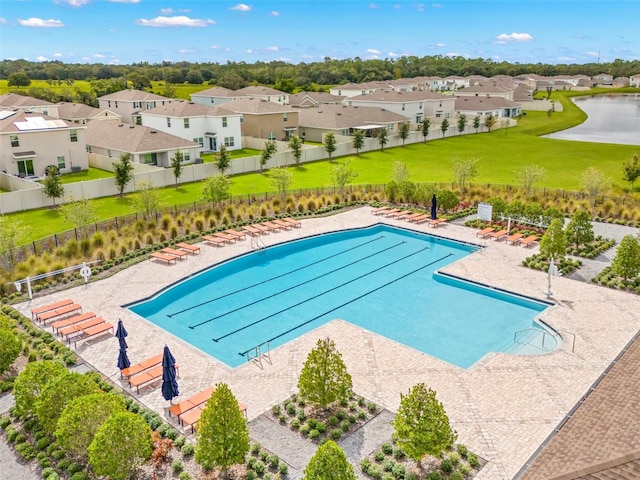 view of swimming pool featuring a lawn