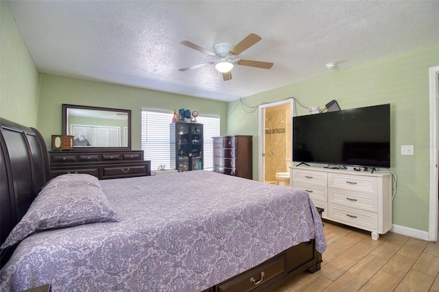 bedroom with ceiling fan, connected bathroom, light hardwood / wood-style floors, and a textured ceiling