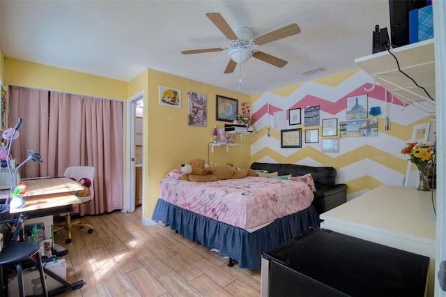 bedroom with ceiling fan and light hardwood / wood-style flooring