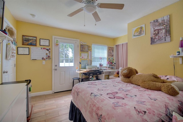 bedroom with ceiling fan and light hardwood / wood-style floors