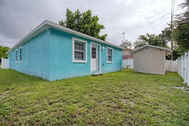 back of property featuring a yard