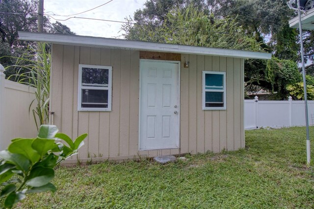 view of outbuilding with a lawn