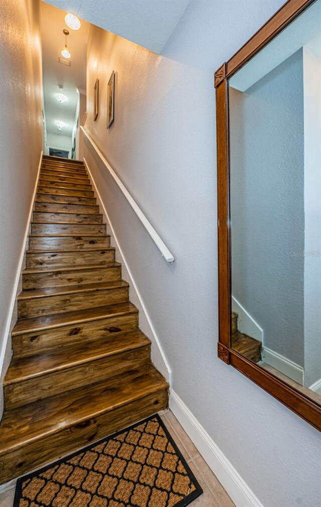 staircase featuring wood-type flooring