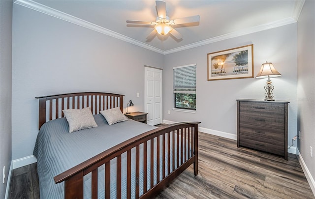 bedroom featuring ornamental molding, ceiling fan, dark hardwood / wood-style floors, and a closet