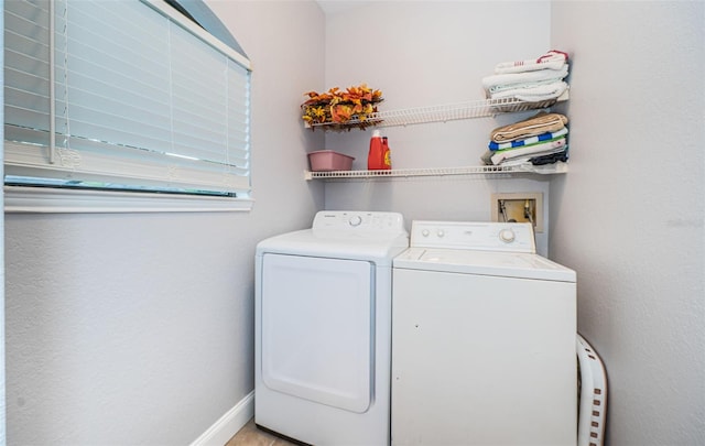 washroom with washing machine and clothes dryer