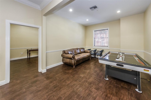 game room with crown molding and dark hardwood / wood-style floors