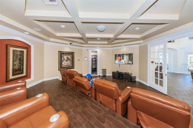 cinema with french doors, dark hardwood / wood-style flooring, beamed ceiling, coffered ceiling, and ceiling fan