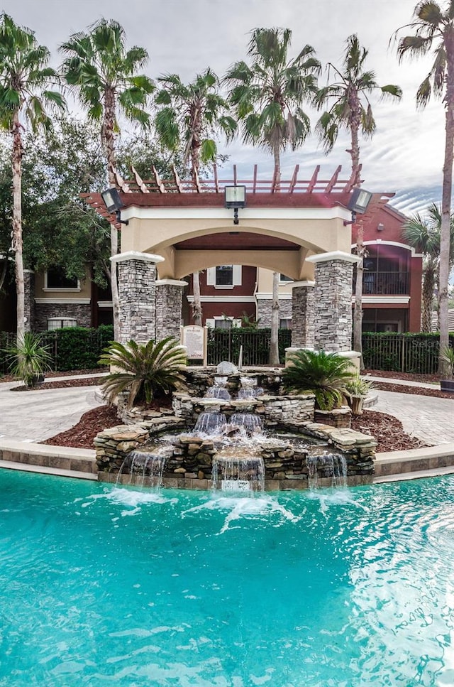 view of pool with pool water feature