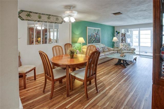 dining room featuring ceiling fan and wood-type flooring