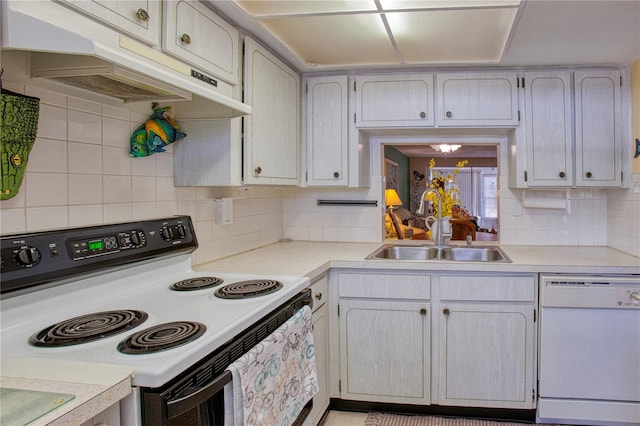 kitchen with white appliances, sink, and tasteful backsplash