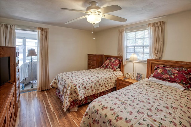 bedroom with wood-type flooring and ceiling fan