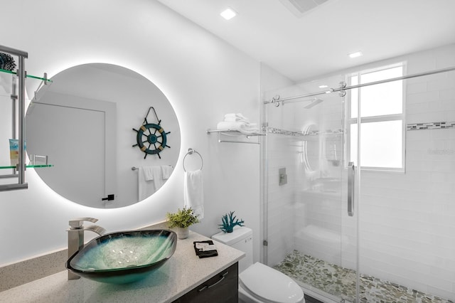 full bathroom with toilet, vanity, a shower stall, and visible vents