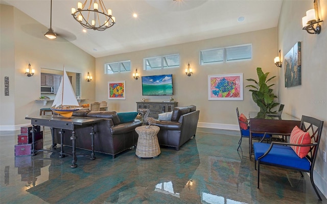 living room with baseboards, high vaulted ceiling, and an inviting chandelier