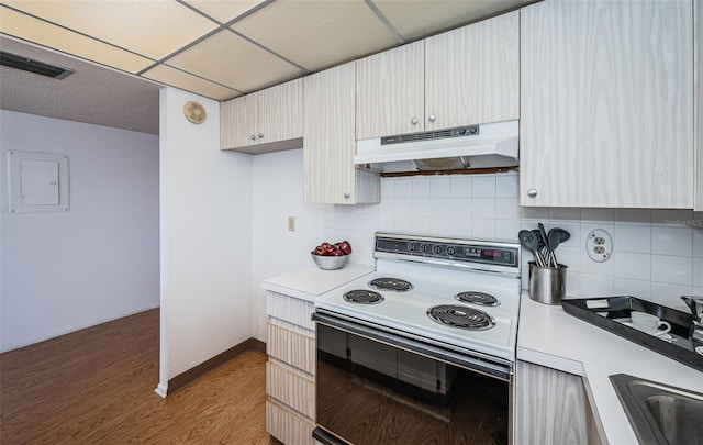 kitchen with dark hardwood / wood-style floors, white electric range, decorative backsplash, electric panel, and a paneled ceiling