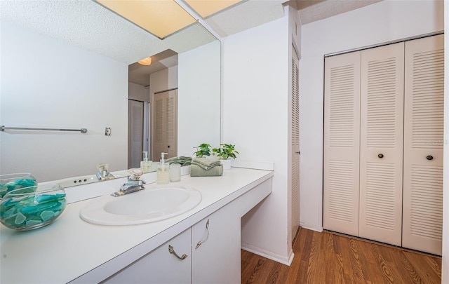 bathroom featuring vanity, a textured ceiling, and hardwood / wood-style flooring