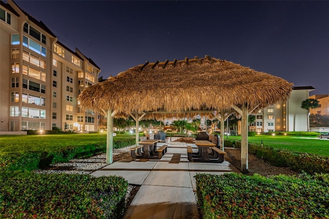 view of property's community with a lawn and a gazebo