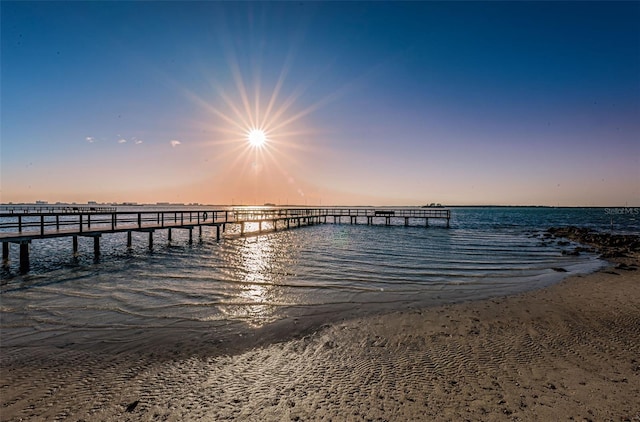 view of dock with a view of the beach and a water view