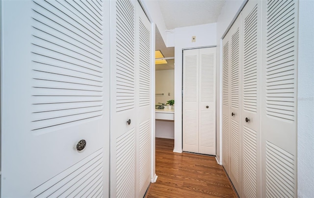 hall featuring hardwood / wood-style flooring and a textured ceiling