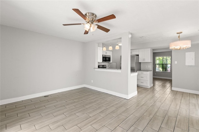 unfurnished living room featuring ceiling fan and light wood-type flooring