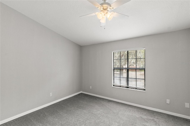 spare room featuring ceiling fan, carpet flooring, and a textured ceiling