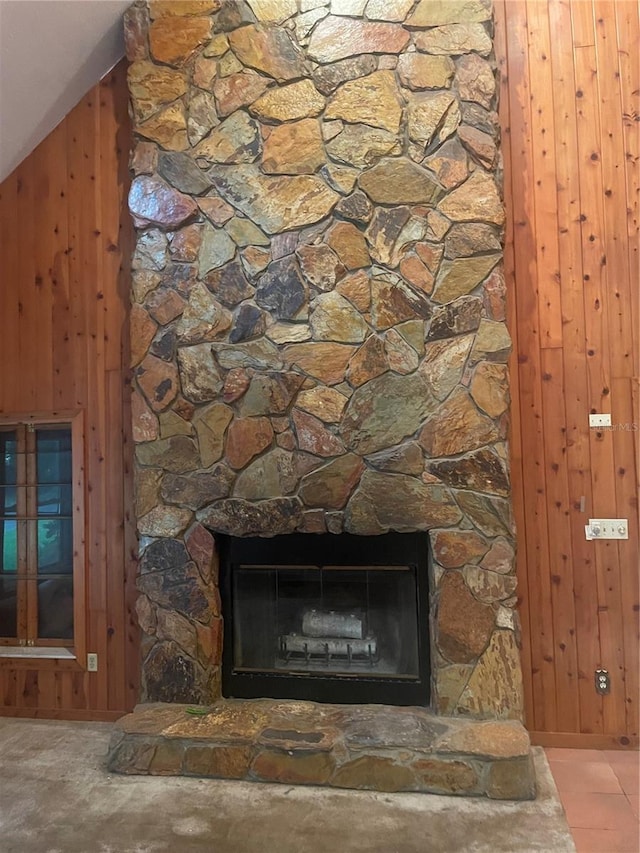 details with a fireplace and wood walls