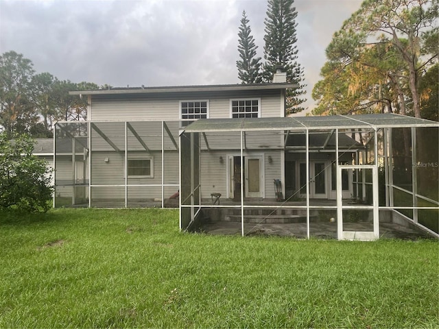 rear view of property with a lawn