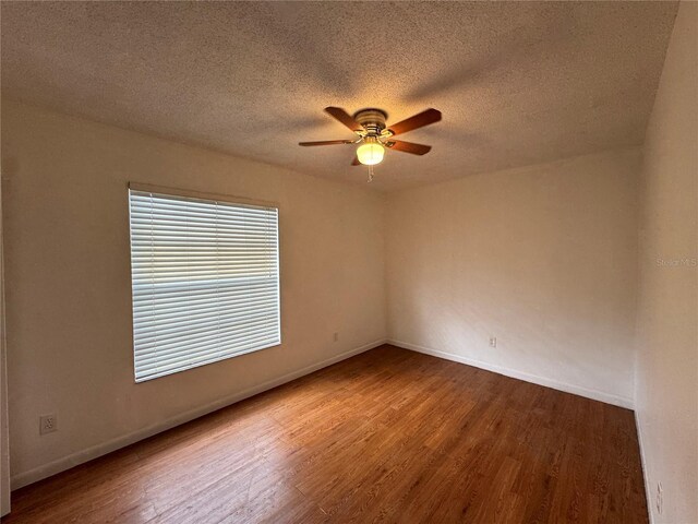 spare room featuring a textured ceiling, hardwood / wood-style floors, and ceiling fan