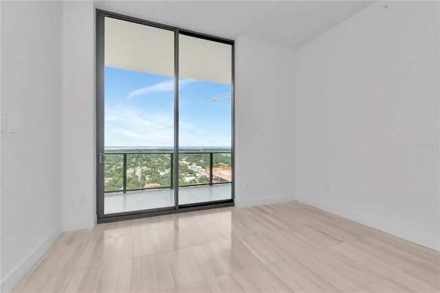 unfurnished room featuring expansive windows