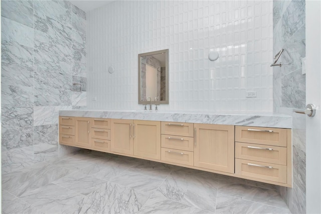 bathroom featuring vanity, tile walls, and a shower