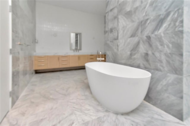 bathroom featuring tile walls, separate shower and tub, and vanity