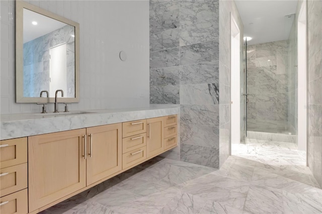 bathroom with a shower with door and vanity