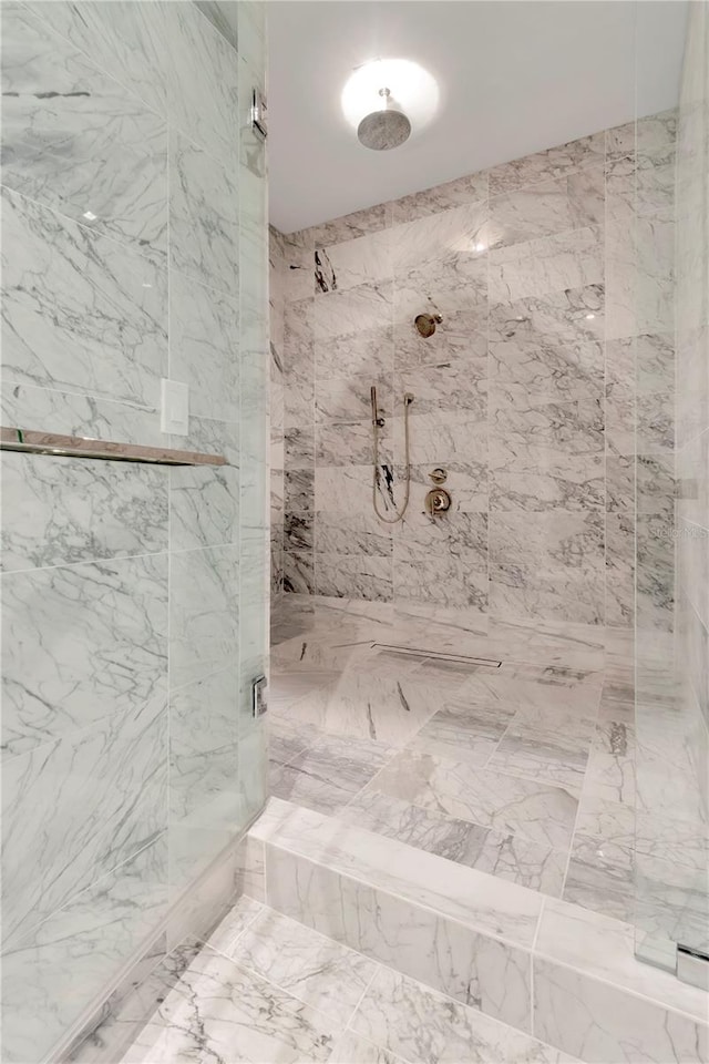 bathroom with a tile shower