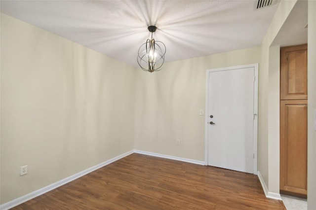 unfurnished room with wood-type flooring