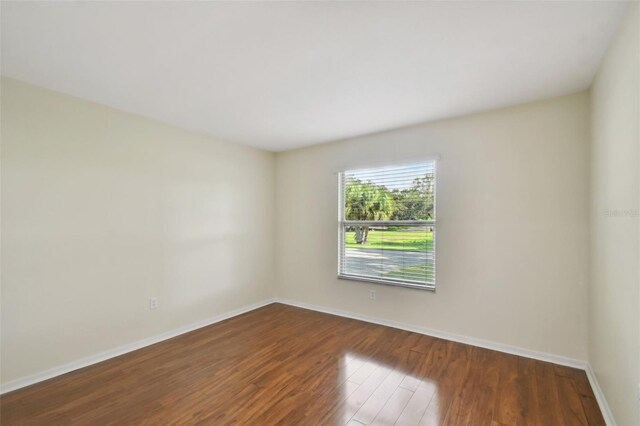 spare room with dark hardwood / wood-style floors