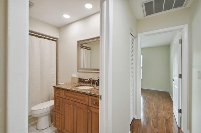 251 Hidden Brook Dr Unit 102C, Palm Harbor, FL 34683 - full bath featuring wood finished floors, vanity, baseboards, toilet, and visible vents