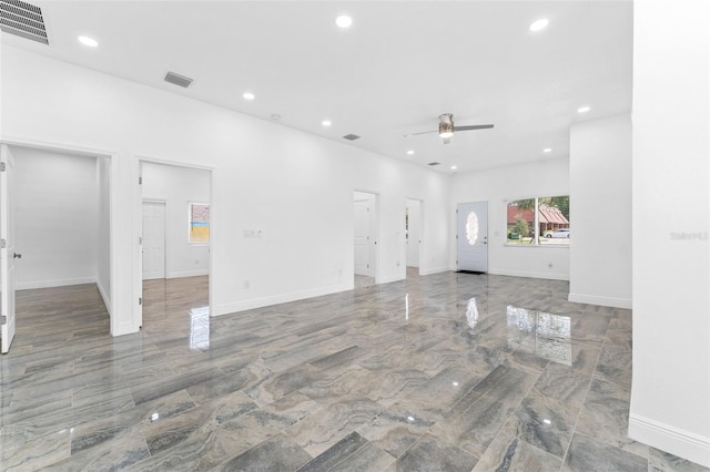 unfurnished living room featuring ceiling fan