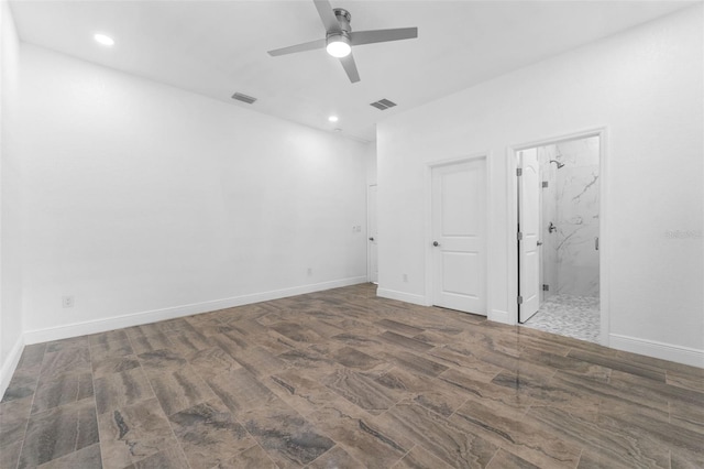 unfurnished bedroom featuring dark wood-type flooring, ceiling fan, and ensuite bath