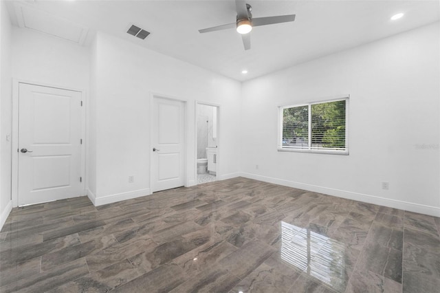 unfurnished bedroom featuring ceiling fan, dark hardwood / wood-style floors, and connected bathroom