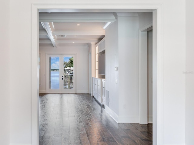 corridor featuring beamed ceiling, coffered ceiling, and dark wood-type flooring