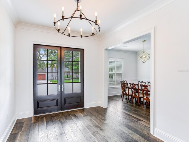 doorway featuring french doors, ornamental molding, an inviting chandelier, and hardwood / wood-style floors